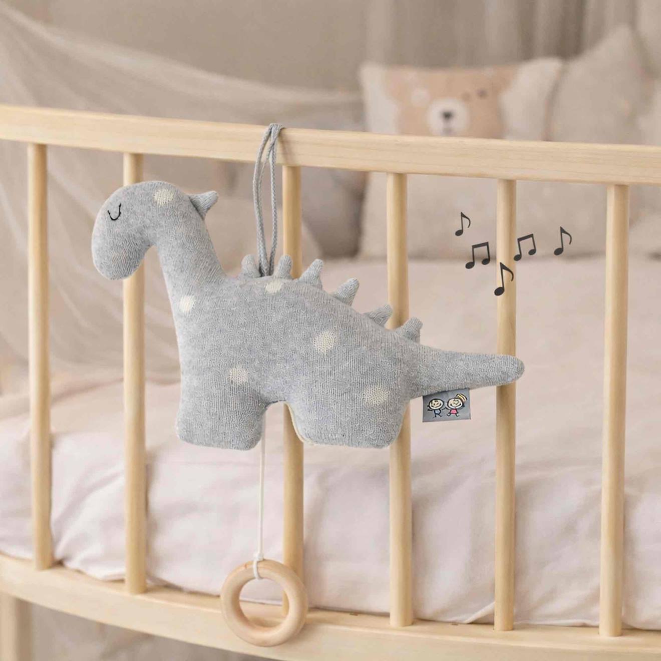 Peluche musicale en tricot de coton dino dino gris