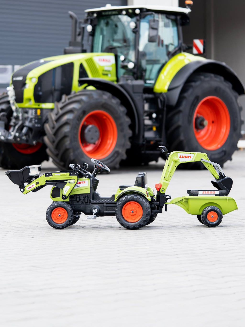 Tractopelle à pédales avec excavatrice arrière et remorque vert claas