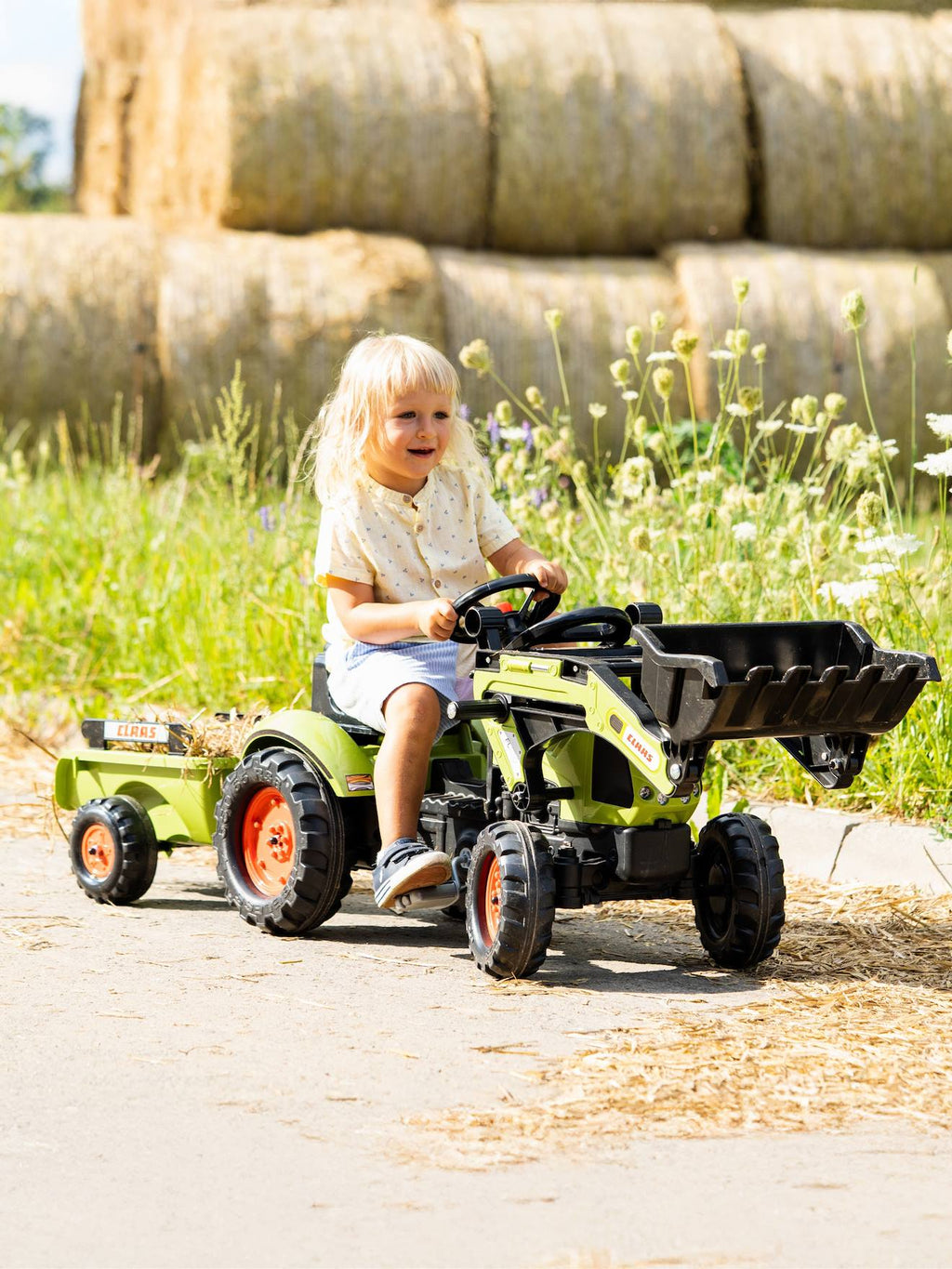 Tractopelle à pédales avec remorque vert claas